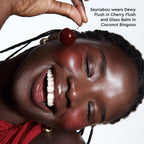 A different close-up captures Cherry Flush freshly applied and blending into a model's cheek.