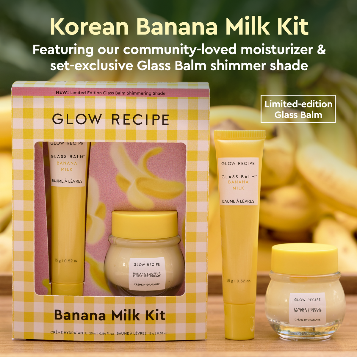 Glow Recipe Banana Milk Kit with packaging, glass balm, and cream on a wooden surface with banana background.