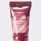 Stylized flat-lay of the Glass Balm tube in Fig Bingsoo arranged with dessert-inspired props.